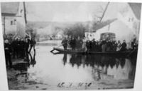 Beförderung der Bevölkerung mit einem Kahn durch die überflutete Ortschaft beim Hochwasser 1920